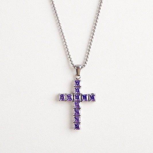 A silver cross pendant necklace adorned with square-cut purple gemstones, suspended from a silver ball chain against a plain white background.
