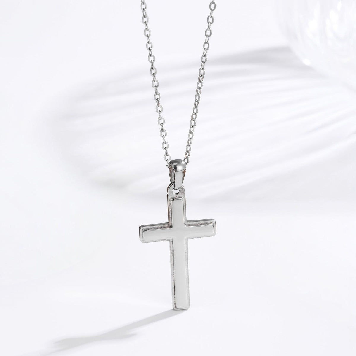 Men's steel silver classic cross necklace lifestyle flat lay