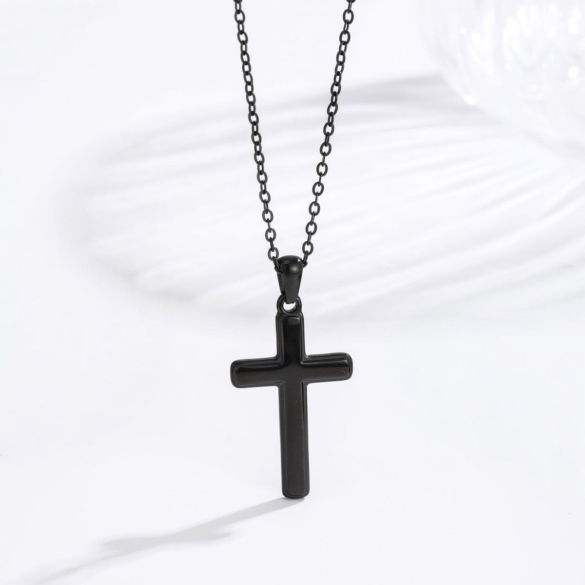 Men's black classic cross necklace lifestyle flat lay
